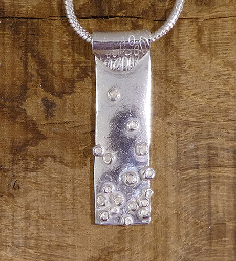 Textile-themed pendant