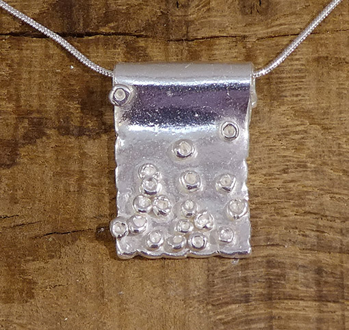 Textile-themed pendant